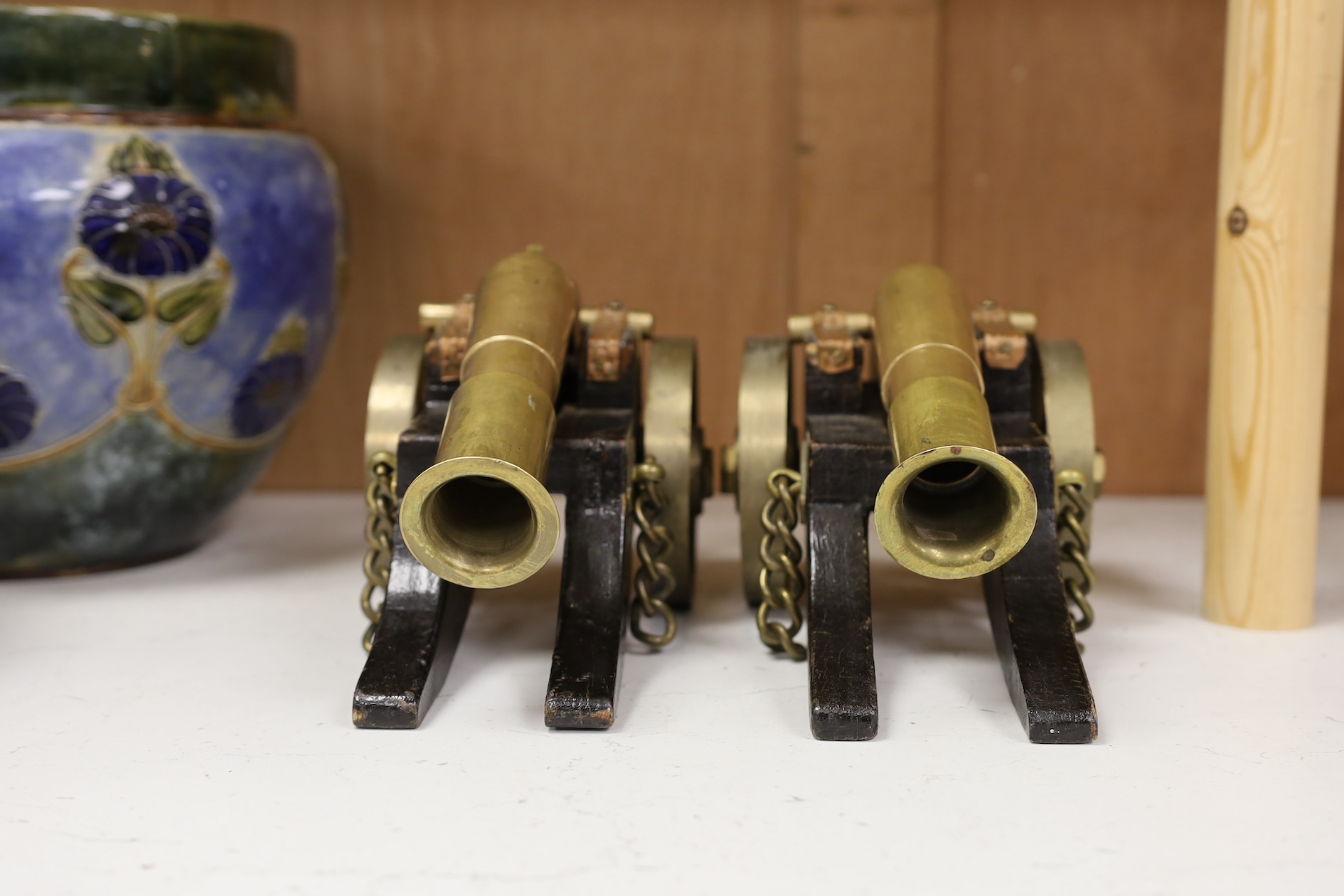 A pair of model bronze and wooden cannons, 27cm long. Condition - worn, strapping rusty